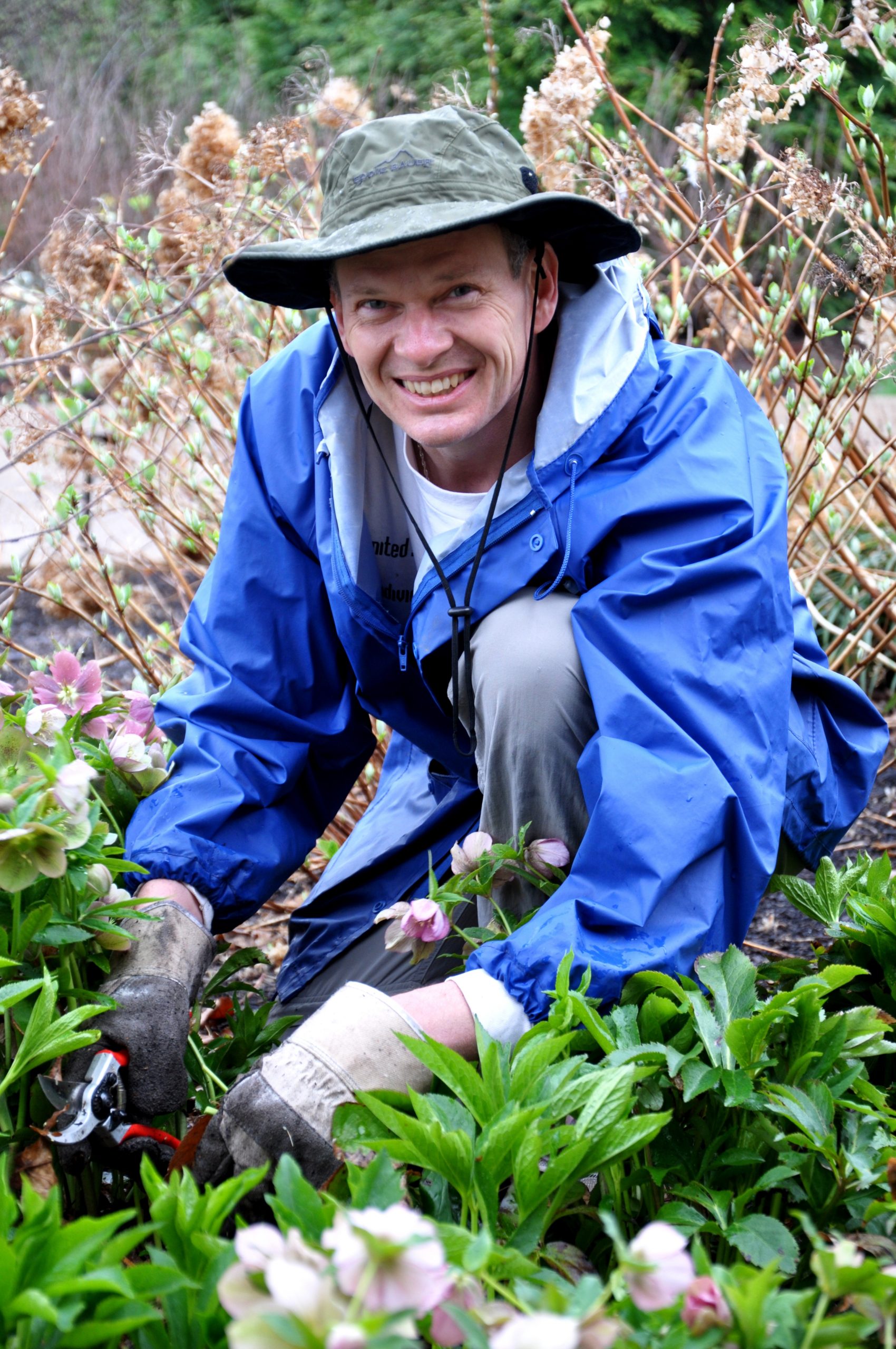 smiling volunteer works in garden