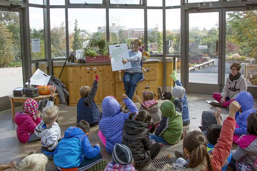 children attend a learning session inside greenhouse