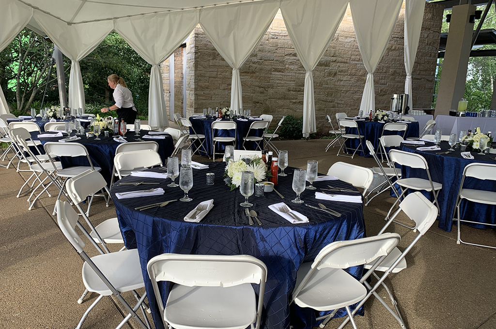 caterer makes final preparations to wedding reception tables