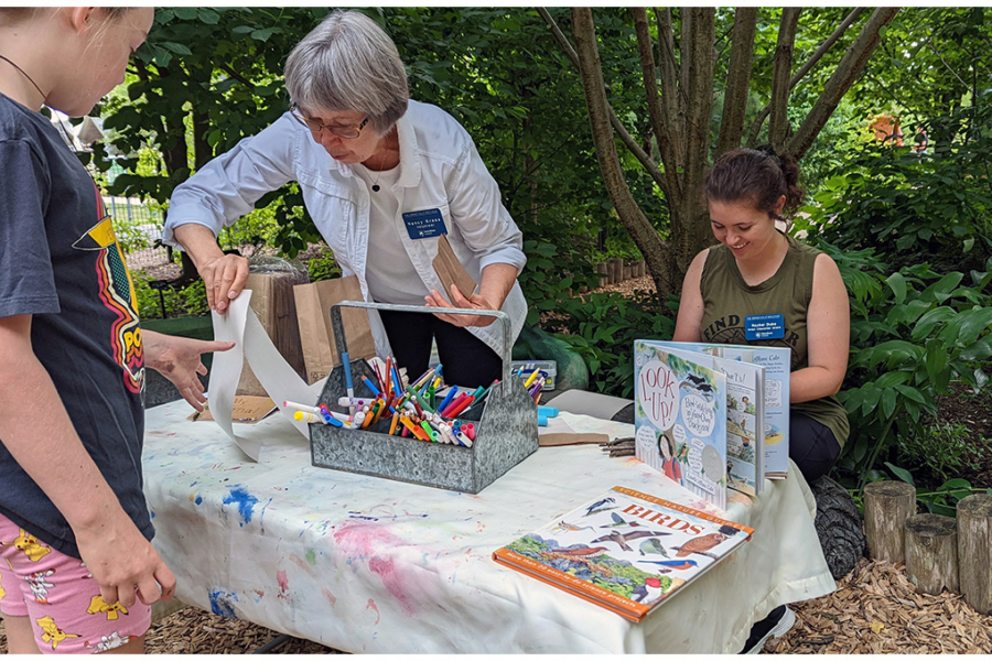 volunteers preside over a children's art station