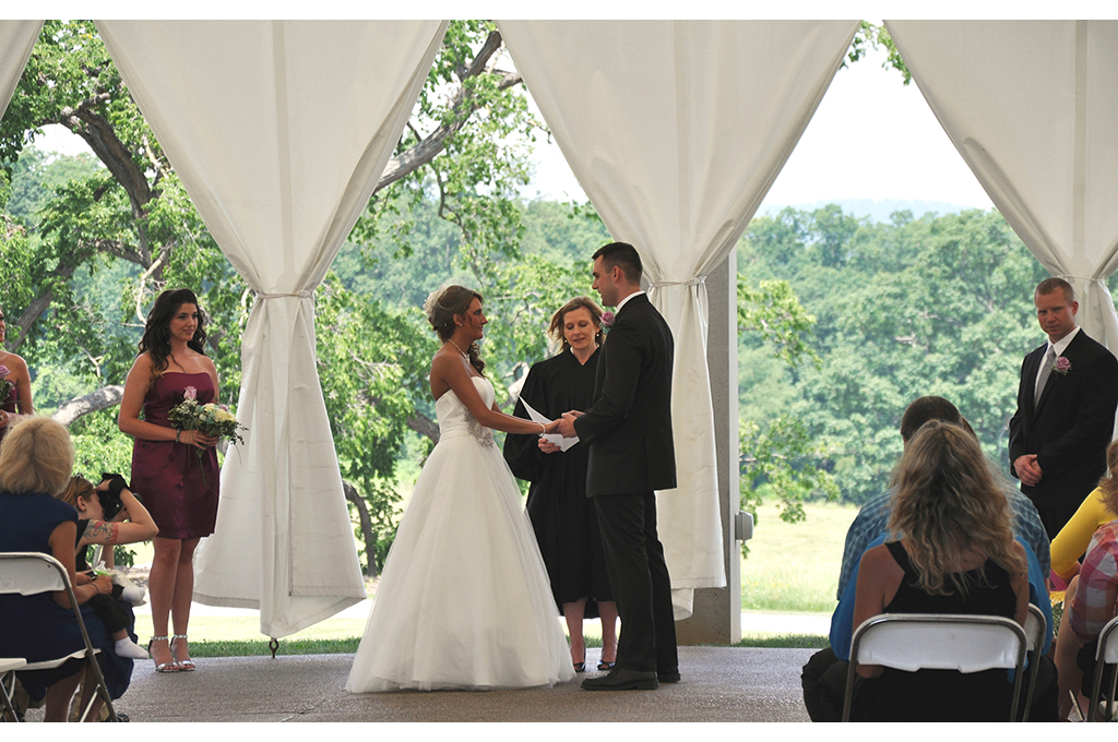 couple exchanges wedding vows at outdoor pavilion