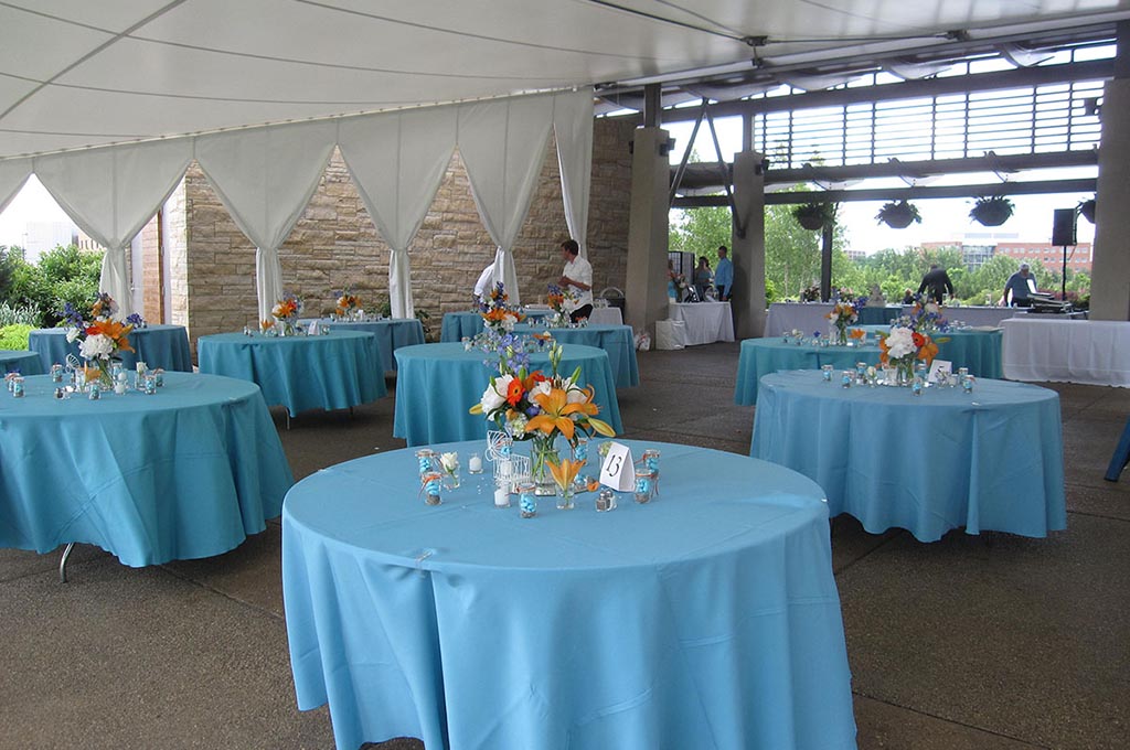 series of event tables with blue tablecloths