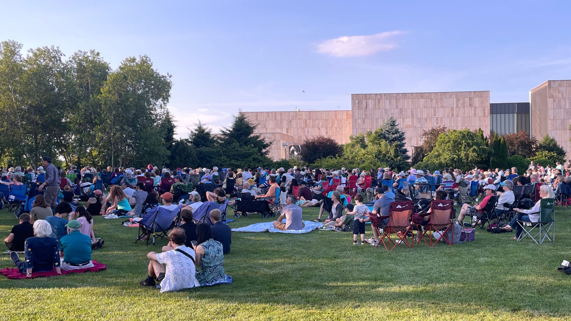 People gather on the Event Lawn at the Arboretum on a summer evening.